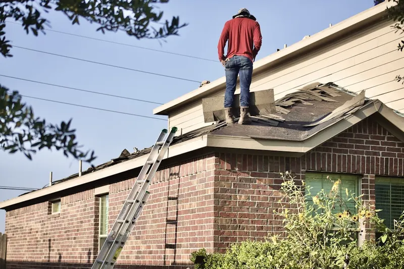 Professional roofer working on a residential roof in Bowers Landing
